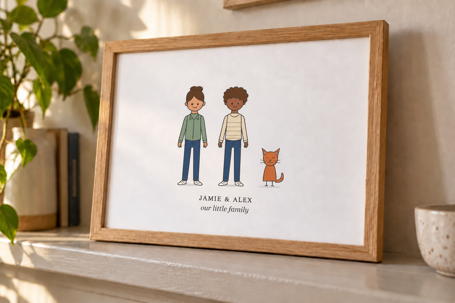 Personalised portrait of Jamie and Alex with their cat, displayed in an oak frame on a shelf